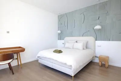 a bedroom with a white bed and a piano at Tigliola Resort in Porto-Vecchio