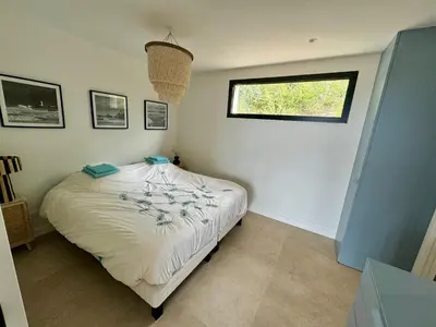 a bedroom with a bed with a window in it at T2 standing 50m2, vue mer in Albitreccia