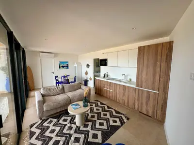 a living room with a couch and a table at T2 standing 50m2, vue mer in Albitreccia