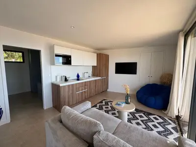 a living room with a couch and a kitchen at T2 standing 50m2, vue mer in Albitreccia
