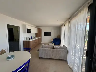 a living room with a couch and a table at T2 standing 50m2, vue mer in Albitreccia