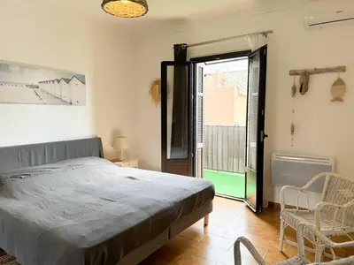 a bedroom with a bed and a large window at Joli T3 moderne avec vue imprenable sur la mer in Propriano