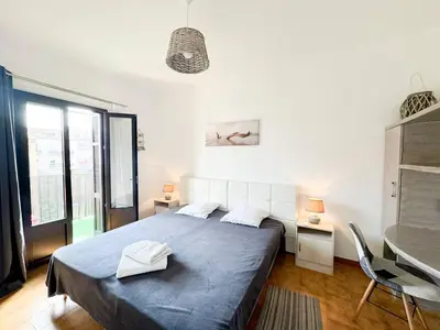 a bedroom with a large bed with a blue blanket at Joli T3 moderne avec vue imprenable sur la mer in Propriano