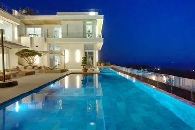 a villa with a swimming pool at night at Villa Tigliola in Porto-Vecchio