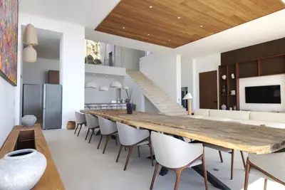 a large dining room with a long table and chairs at Villa Tigliola in Porto-Vecchio