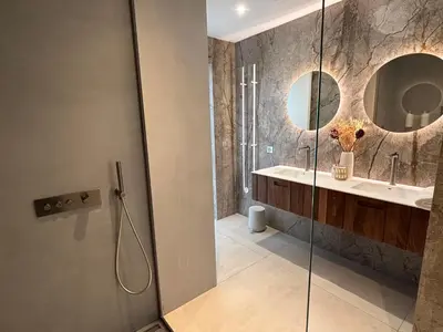 a bathroom with a shower and a sink and a mirror at Villa Tigliola in Porto-Vecchio