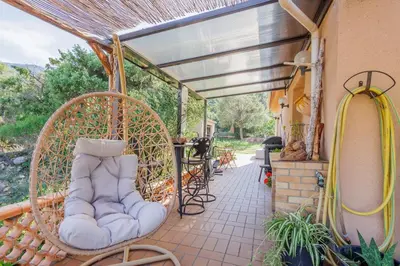 a porch with a swing and a shower at Maison du Fangu - Da Simone - Maison de 160 m2 in Galeria