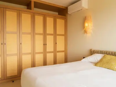 a bedroom with a bed and a closet at Résidence & Villas Oradoro - Proche Île Rousse in Belgodère