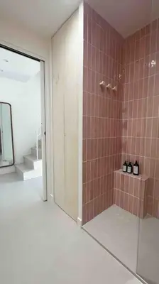 a bathroom with a shower with a glass door at LA GRANDE JANE petite villa bord de mer in Borgo