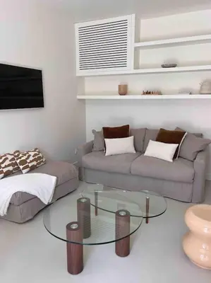 a living room with a couch and a glass table at LA GRANDE JANE petite villa bord de mer in Borgo