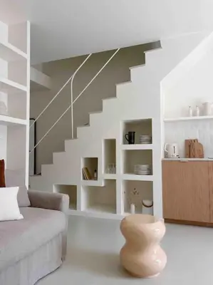a living room with a couch and a staircase at LA GRANDE JANE petite villa bord de mer in Borgo