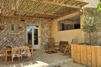 a patio of a house with a table and chairs at T2 Mare - Casa Mattea in Aléria