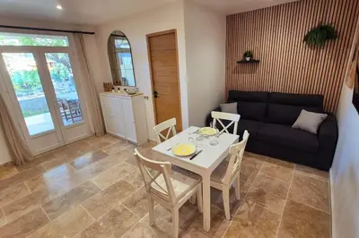 a living room with a table and a couch at T2 Mare - Casa Mattea in Aléria