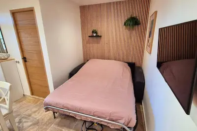 a small bedroom with a bed in a room at T2 Mare - Casa Mattea in Aléria