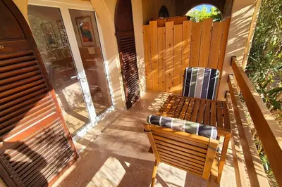 a porch with two benches and a window at T2 Mare - Casa Mattea in Aléria