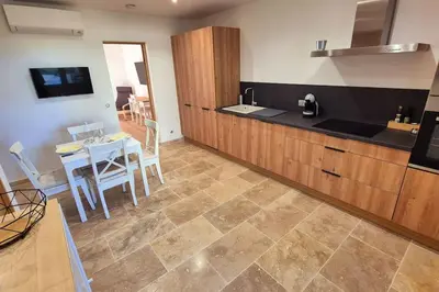 a kitchen with a table and a counter top at T2 Mare - Casa Mattea in Aléria