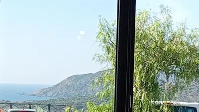 a view of the ocean from a window at T2 neuf situation Topissime village de Cargèse Vue mer Toutes commodités in Cargèse