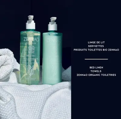 two shampoo bottles sitting on top of white towels at A Vista - Villa luxe, piscine, vue mer panoramique - Classée 4 étoiles in Figari