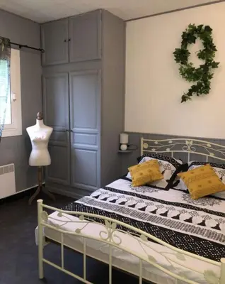 a bedroom with a bed with yellow pillows on it at Location Estivale en Haute Corse in Scata