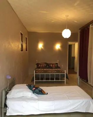 a bedroom with a bed in the corner of a room at Location Estivale en Haute Corse in Scata
