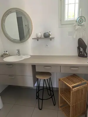 a bathroom with a sink and a mirror at Villa élégante piscine privée Palombaggia Porto-vecchio in Porto-Vecchio