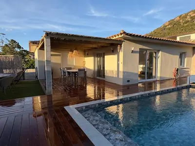 a house with a deck and a swimming pool at Villa élégante piscine privée Palombaggia Porto-vecchio in Porto-Vecchio