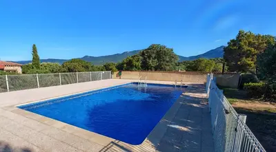 a swimming pool in a yard with a fence at Villa KALLISTE 3 pièces avec vue mer sur les hauteurs de Propriano in Propriano