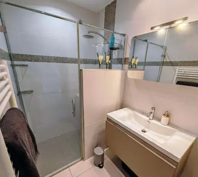 a bathroom with a glass shower and a sink at Villa KALLISTE 3 pièces avec vue mer sur les hauteurs de Propriano in Propriano