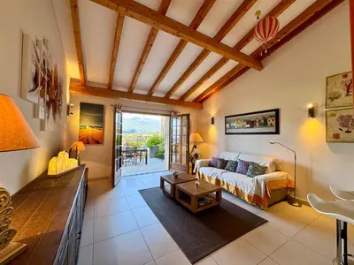 a living room with a couch and a table at Villa KALLISTE 3 pièces avec vue mer sur les hauteurs de Propriano in Propriano