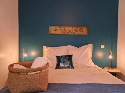 a bedroom with a large bed with a chair at Mini villa 70 - piscine chauffée in Serra-di-Ferro