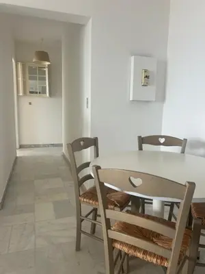 a dining room with a table and chairs at T2 vue mer à 8 min du centre ville d'Ajaccio et 1 min des plages in Ajaccio