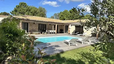 a villa with a swimming pool and a house at Les Villas de Fiori Di Cala Rossa in Lecci