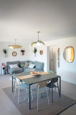 a living room with a table and a couch at Les Villas de Fiori Di Cala Rossa in Lecci
