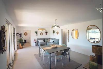 a living room with a table and a couch at Les Villas de Fiori Di Cala Rossa in Lecci