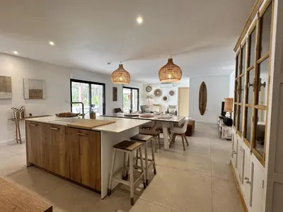 a large kitchen with a large island in a room at Les Villas de Fiori Di Cala Rossa in Lecci