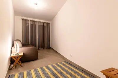 a living room with a couch and a rug at Agosta Bella - Appt en face de la plage dAgosta in Albitreccia