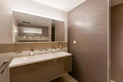 a bathroom with a sink and a mirror at Agosta Bella - Appt en face de la plage dAgosta in Albitreccia