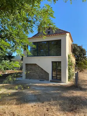 a house with a large window on top of it at Maison cantonnière in Sartène