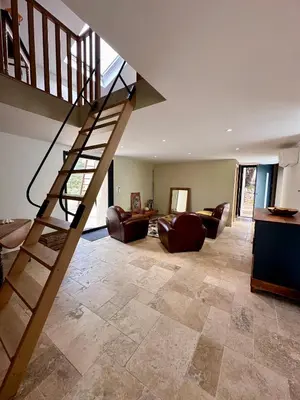 a living room with a staircase in a house at Maison cantonnière in Sartène