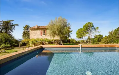 a swimming pool in front of a house at Awesome Home In Coti-Chiavari in Coti-Chiavari