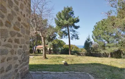 a view of a yard with trees and a building at Awesome Home In Coti-Chiavari in Coti-Chiavari