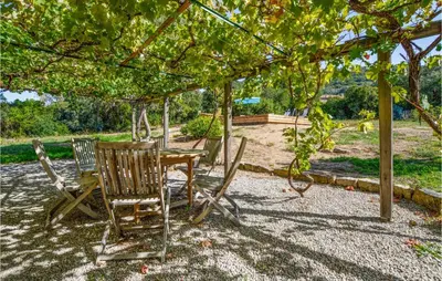 a table and chairs sitting under a pergola at Awesome Home In Coti-Chiavari in Coti-Chiavari