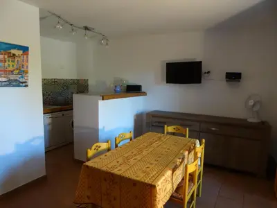 a bedroom with a white bed and a window at Les Voutes in Propriano