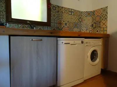 a bedroom with a bed with two night stands and two lamps at Les Voutes in Propriano