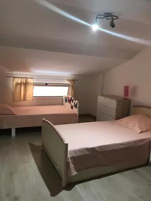a bedroom with two beds and a window at Charmante Maisonnette t2bis plaine de Calenzana in Calenzana