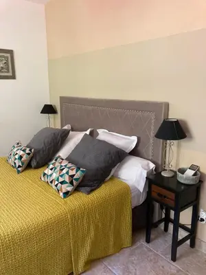 a bedroom with a bed with two pillows on it at Domaine U Bugnu in Vico