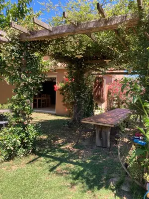 a picnic table in a garden with a pergola at Domaine U Bugnu in Vico