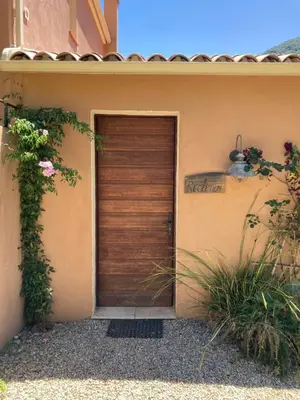 a wooden door on the side of a house at Domaine U Bugnu in Vico