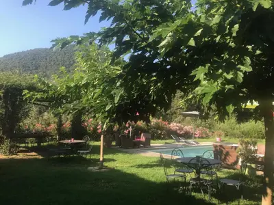 a park with tables and chairs in the grass at Domaine U Bugnu in Vico