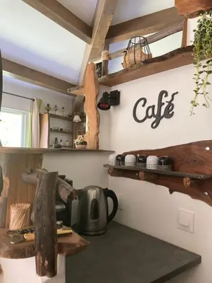 a kitchen with a coffee pot on a shelf at Domaine U Bugnu in Vico